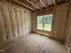Bedroom with wood-frame construction, insulation, and natural light at 2776 Rains Mill Rd, Princeton, NC 27569