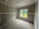 Unfinished bedroom with drywall and a window overlooking a green view at 2776 Rains Mill Rd, Princeton, NC 27569