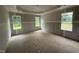 A bedroom under construction featuring drywall, a tray ceiling, and natural light streaming through the windows at 2776 Rains Mill Rd, Princeton, NC 27569