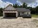 Exterior view of new home construction featuring attached garage and dumpster at 2776 Rains Mill Rd, Princeton, NC 27569