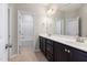 This well-lit bathroom features a double vanity with modern fixtures and plenty of counter space at 2855 Wilkes Lake Dr, Fuquay Varina, NC 27526