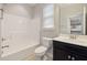 Well-lit bathroom features a shower-tub combination and a sleek vanity with a modern sink at 2855 Wilkes Lake Dr, Fuquay Varina, NC 27526