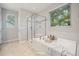 Relaxing bathroom featuring a soaking tub, separate glass shower, and stylish tile work at 2855 Wilkes Lake Dr, Fuquay Varina, NC 27526