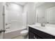 This bathroom features a shower-tub combination with sleek hardware and vanity with modern sink at 2855 Wilkes Lake Dr, Fuquay Varina, NC 27526