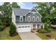 Two-story home featuring a two-car garage, neutral siding and colorful accent shutters at 2855 Wilkes Lake Dr, Fuquay Varina, NC 27526