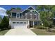 Charming two-story home featuring a manicured lawn, attached garage, and inviting front porch at 2855 Wilkes Lake Dr, Fuquay Varina, NC 27526