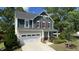 Charming two-story home showcasing a manicured lawn, attached garage, and inviting front porch at 2855 Wilkes Lake Dr, Fuquay Varina, NC 27526