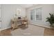 Bright home office with a neutral rug, modern desk, and a large window at 2855 Wilkes Lake Dr, Fuquay Varina, NC 27526