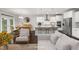 Open concept kitchen with white cabinets, stainless steel appliances, and island with bar stools at 2855 Wilkes Lake Dr, Fuquay Varina, NC 27526