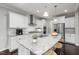 Bright kitchen with white cabinets, granite counters, and stainless steel appliances at 2855 Wilkes Lake Dr, Fuquay Varina, NC 27526