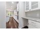Long kitchen with granite counters, white cabinets, and stainless steel appliances at 2855 Wilkes Lake Dr, Fuquay Varina, NC 27526