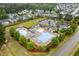 Aerial view of the community pool with lounge chairs, splash pad, and playground at 2855 Wilkes Lake Dr, Fuquay Varina, NC 27526