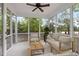 Screened porch featuring a ceiling fan and cozy furniture for relaxing outdoors at 2855 Wilkes Lake Dr, Fuquay Varina, NC 27526
