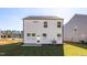Exterior view of the backyard and home with green grass and blue skies at 293 Gregory Village Dr, Lillington, NC 27546