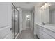 Modern bathroom with double vanity, sleek fixtures, and a glass-enclosed shower; ample counter space at 293 Gregory Village Dr, Lillington, NC 27546