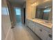 Bathroom features a double sink vanity, contemporary lighting, and an attached glass shower at 293 Gregory Village Dr, Lillington, NC 27546