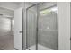 Modern glass-enclosed shower with gray tile and an integrated window, creating a bright and airy bathroom at 293 Gregory Village Dr, Lillington, NC 27546