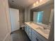 Modern bathroom with double sink vanity, sleek countertops, and contemporary lighting fixtures at 293 Gregory Village Dr, Lillington, NC 27546