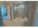 This modern bathroom features a glass shower, marble tiling, and a built-in bench at 293 Gregory Village Dr, Lillington, NC 27546