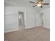 Large bedroom with neutral carpet featuring an open door and access to the en suite bathroom at 293 Gregory Village Dr, Lillington, NC 27546