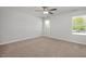 Comfortable bedroom with neutral carpet, a ceiling fan, and natural light from the windows at 293 Gregory Village Dr, Lillington, NC 27546