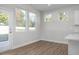 Bright dining area with multiple windows offering backyard views, seamlessly connects to the kitchen space at 293 Gregory Village Dr, Lillington, NC 27546