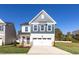 Charming two-story home with landscaped yard and attached two-car garage at 293 Gregory Village Dr, Lillington, NC 27546