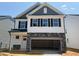 New construction two-story home featuring a two-car garage and stylish architectural details at 293 Gregory Village Dr, Lillington, NC 27546