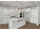 Bright kitchen features stainless appliances, white cabinetry, and large island at 293 Gregory Village Dr, Lillington, NC 27546