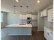 Bright kitchen features modern pendant lighting, stainless appliances, white cabinets, and a spacious island at 293 Gregory Village Dr, Lillington, NC 27546