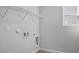 Laundry room with white shelving and bright lighting at 293 Gregory Village Dr, Lillington, NC 27546