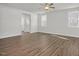 Spacious living room featuring wood-look floors, a ceiling fan, and plenty of natural light from the windows at 293 Gregory Village Dr, Lillington, NC 27546