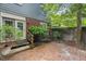 Inviting brick patio and lush landscaping create a peaceful outdoor retreat at 3025 Wycliff Rd, Raleigh, NC 27607