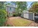 Expansive backyard with brick patio, greenery, and shed providing utility and space at 3025 Wycliff Rd, Raleigh, NC 27607