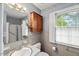 Traditional bathroom featuring a vanity, medicine cabinet, and shower-tub combo, accented by tiled walls at 3025 Wycliff Rd, Raleigh, NC 27607