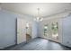 Traditional dining room with blue walls, carpet, and glass doors to the backyard at 3025 Wycliff Rd, Raleigh, NC 27607