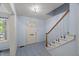 Entryway with tiled floors, front door, and staircase leading to the second floor at 3025 Wycliff Rd, Raleigh, NC 27607