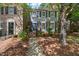 Charming two-story townhouse featuring blue shutters and an American flag at 3025 Wycliff Rd, Raleigh, NC 27607