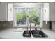 Close up of a kitchen sink and window overlooking the backyard at 3025 Wycliff Rd, Raleigh, NC 27607