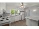 Well-lit kitchen with white appliances, countertops, and a window over the sink at 3025 Wycliff Rd, Raleigh, NC 27607
