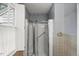 Modern shower with glass doors and grab bar, surrounded by neutral tiled walls for a sleek look at 3025 Wycliff Rd, Raleigh, NC 27607