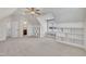 Large bedroom with carpet, built-in shelves and storage around the windows and a peek into ensuite at 3108 Lawson Walk Way, Rolesville, NC 27571