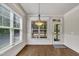 Bright breakfast nook features hardwood floors, a window overlooking backyard and a glass paneled door leading outside at 3108 Lawson Walk Way, Rolesville, NC 27571