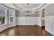 Spacious dining room featuring hardwood floors, wainscoting, and a chandelier, perfect for entertaining at 3108 Lawson Walk Way, Rolesville, NC 27571