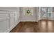 Elegant foyer featuring hardwood floors, wainscoting, and a front door with sidelights at 3108 Lawson Walk Way, Rolesville, NC 27571