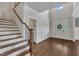 Bright foyer with hardwood floors, a staircase, and a view of the front door at 3108 Lawson Walk Way, Rolesville, NC 27571