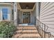 Inviting front entrance with brick steps, a wood door, and a decorative wreath for a warm welcome at 3108 Lawson Walk Way, Rolesville, NC 27571