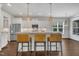 Bright eat-in kitchen features granite countertops, stainless steel appliances, and three pendant lights above the island at 3108 Lawson Walk Way, Rolesville, NC 27571