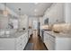 Spacious kitchen features long granite countertops, stainless steel appliances, and white cabinetry with under cabinet lighting at 3108 Lawson Walk Way, Rolesville, NC 27571