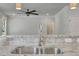 Kitchen sink with chrome faucet set in granite countertop overlooking the living room and doorway with ceiling fan at 3108 Lawson Walk Way, Rolesville, NC 27571